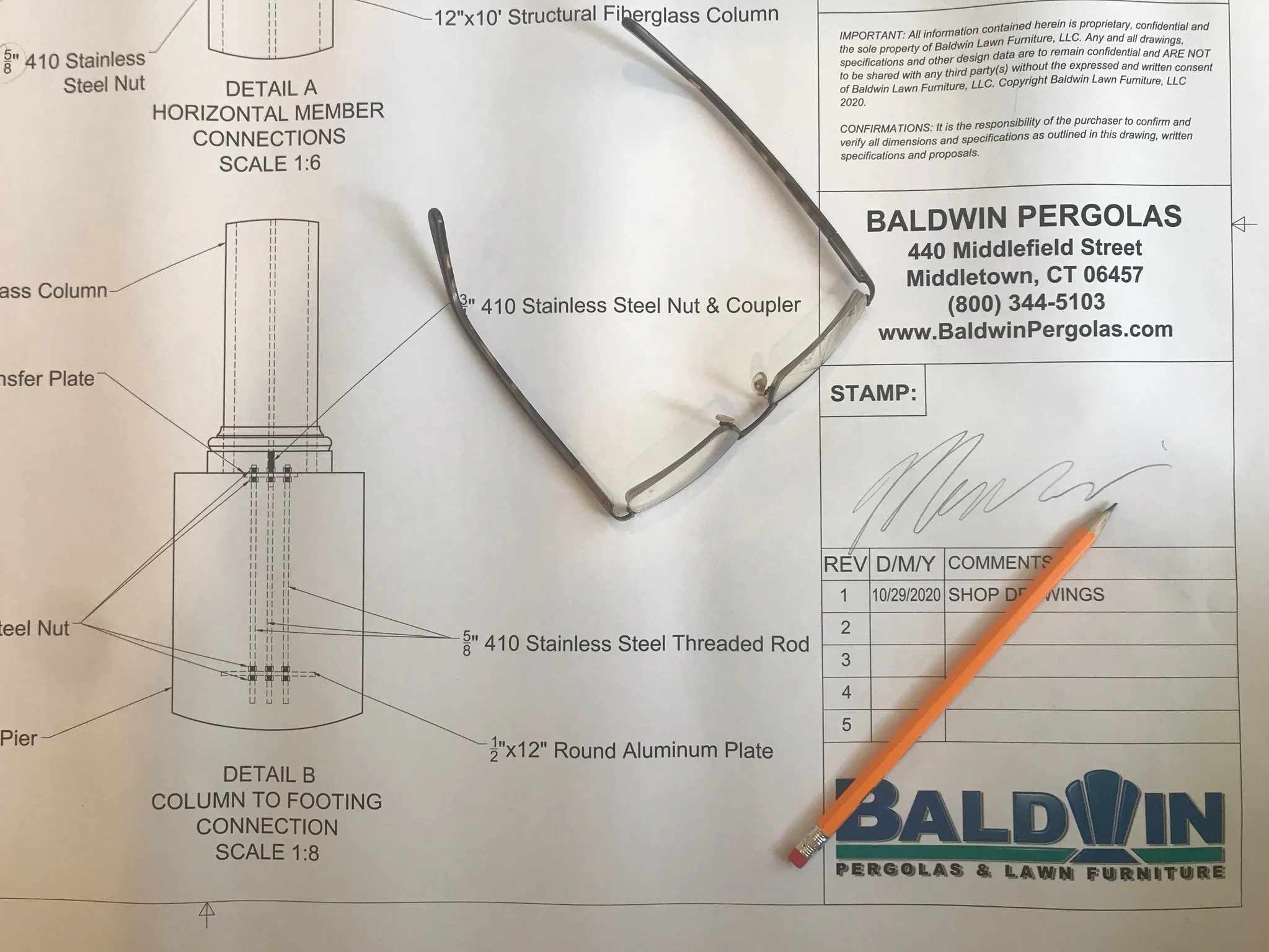 Photo of technical drawings being approved for production